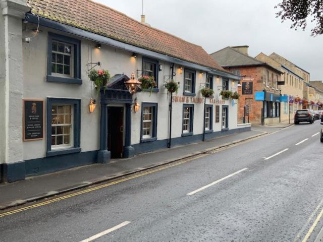 a row of buildings on the side of a street at Swan & Talbot Inn in Wetherby