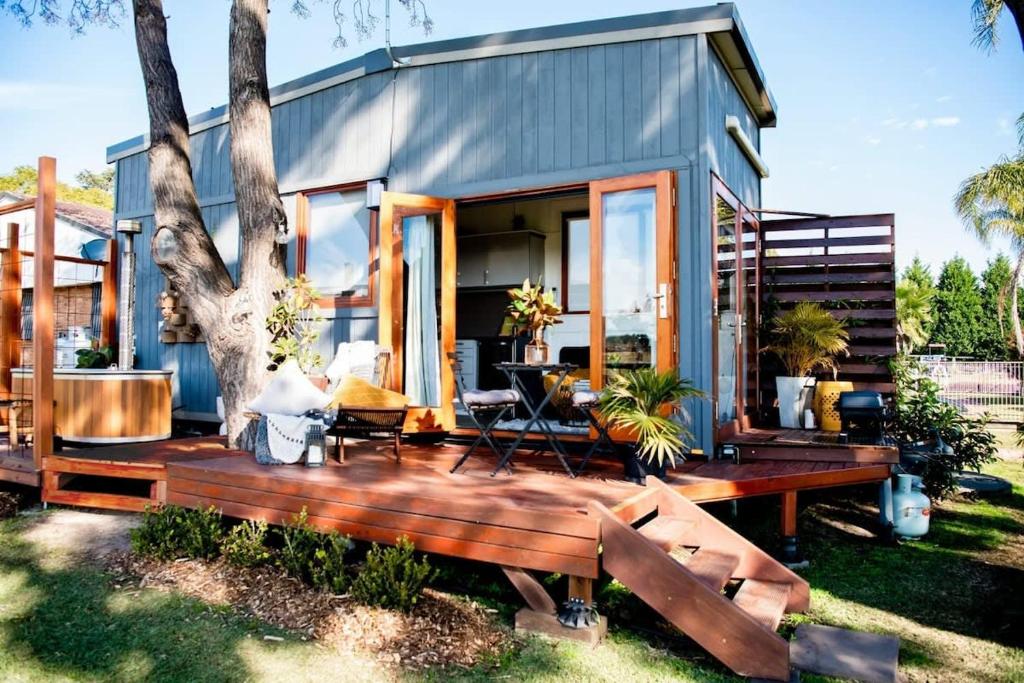 a tiny house with a wooden deck at 6Sixteen The Banks in Richmond