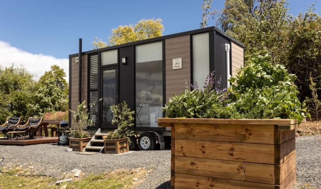 a tiny house on a trailer with a garden at Belrose Estate in Dumbalk