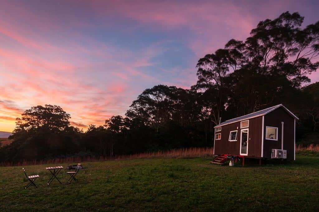 a tiny house in a field at sunset at Little Magic on Magic Mountain in Coolangatta