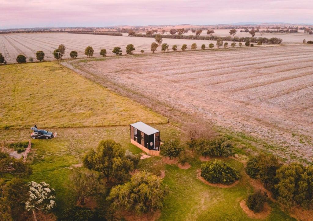 an aerial view of a house in a field at Tiny Balloon House in Canowindra