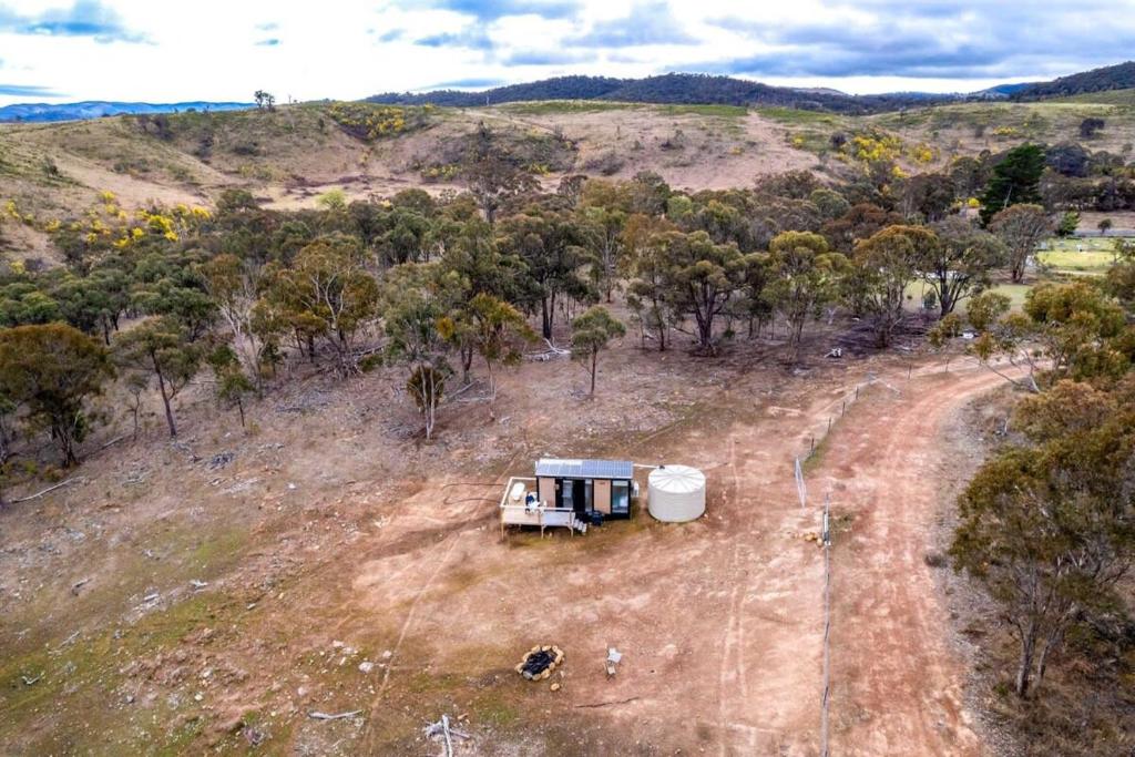 an rv parked in the middle of a field at Cabernet Tiny House in Windeyer