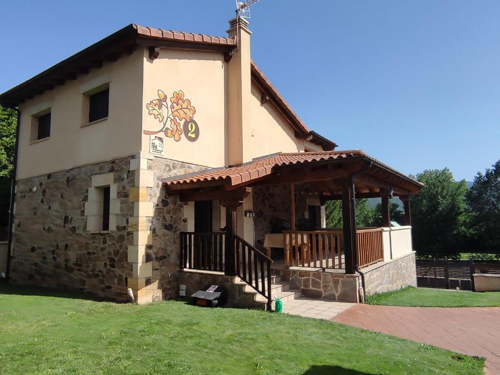 a small building with a porch and a roof at Los Robles 2 in Soria