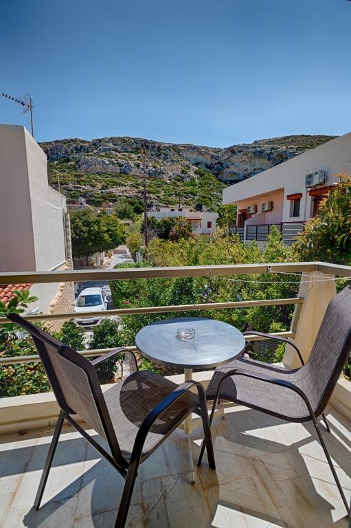 a table and chairs on a balcony with a view at Fantastic Matala 1 in Matala