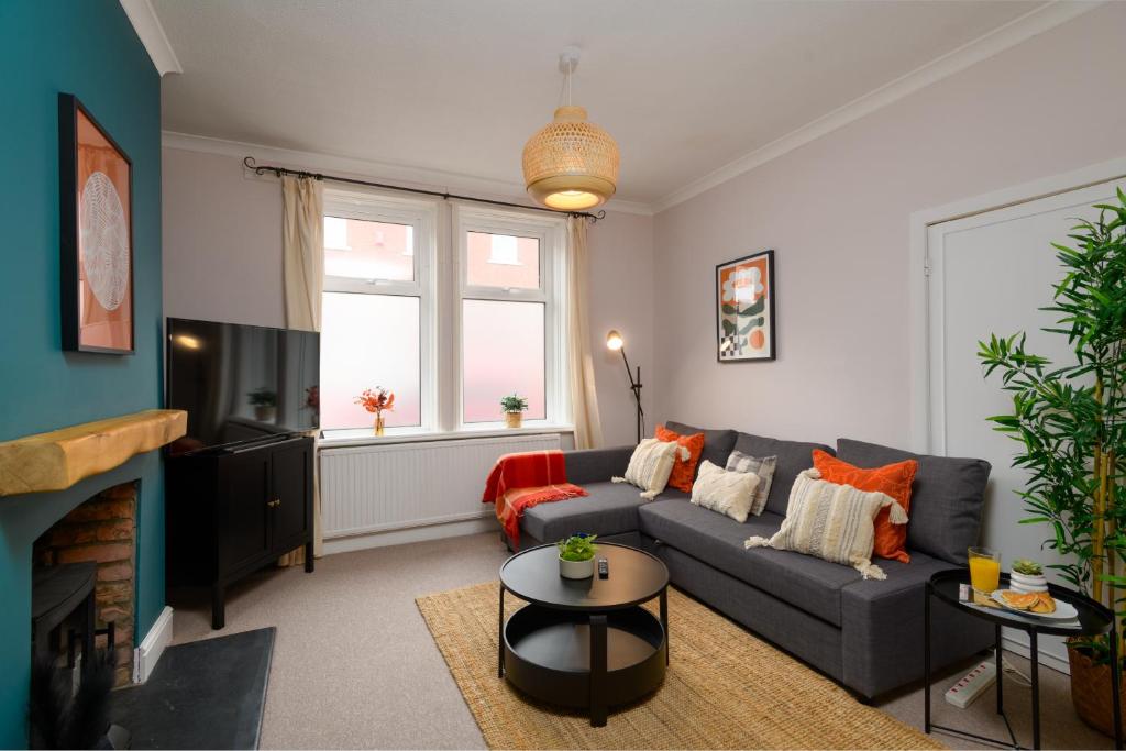 a living room with a couch and a tv at Joseph Suite by Koya Homes in Barry