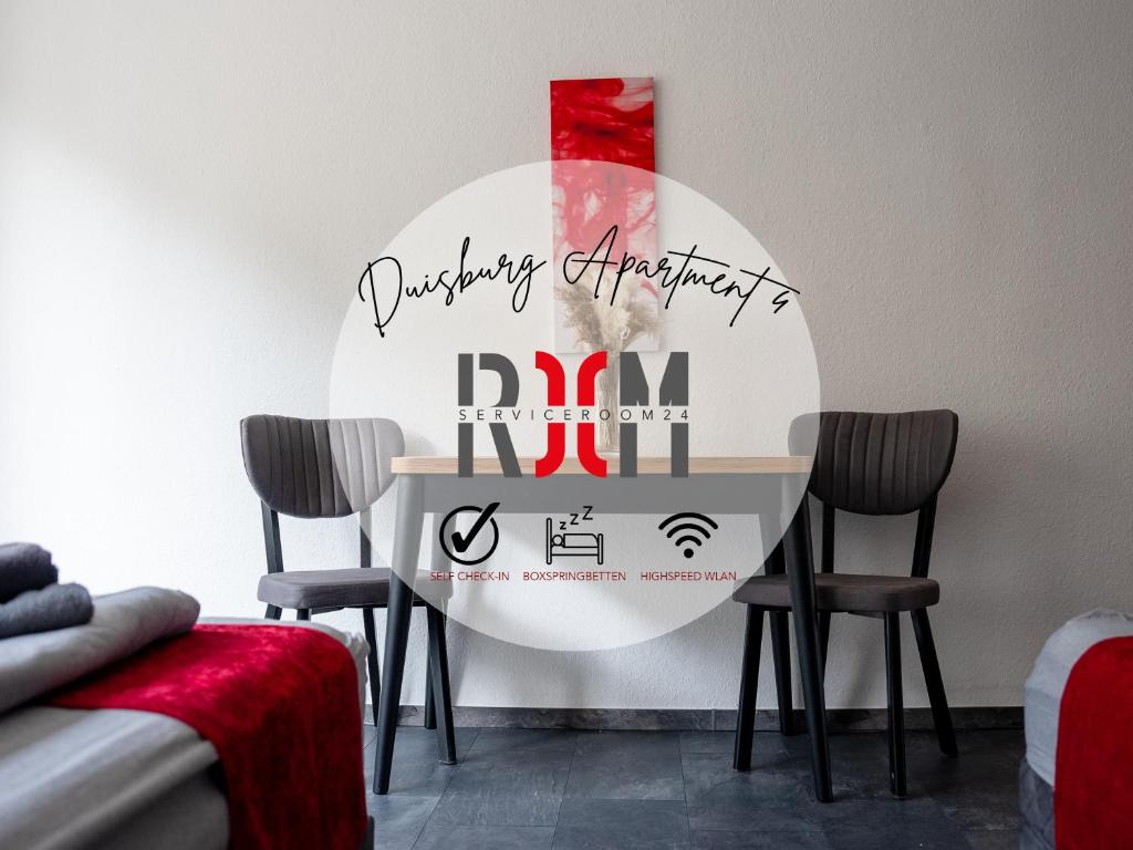 a table with chairs and a sign for adqdqietyietyietyeaten at SR24 - Wohnung in Duisburg 4 in Duisburg