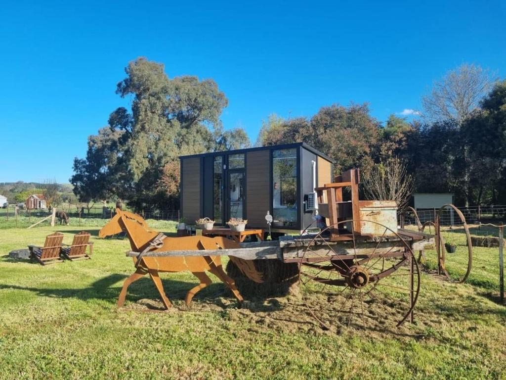 a tiny house on a cart in a field at JBJK Homestead in Yarck