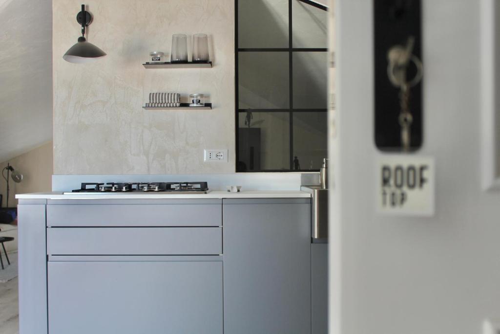 uma cozinha branca com um lavatório e um espelho em ROOFTOP A casa di Tatta - apartments by the sea em Francavilla al Mare