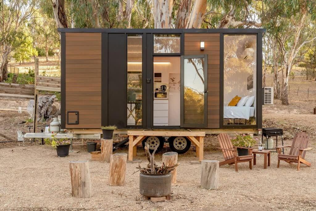 a tiny house sitting on a wooden table at Summer Lea 2 in Howes Creek