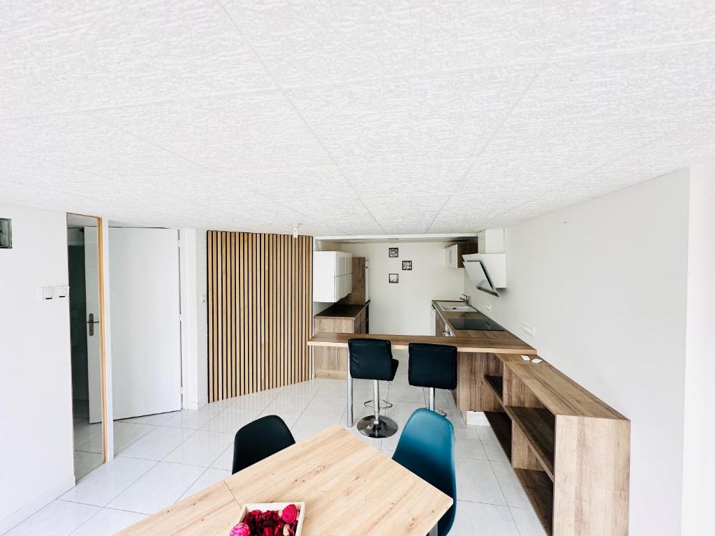 a kitchen and dining room with a wooden table and chairs at maison in Cholet