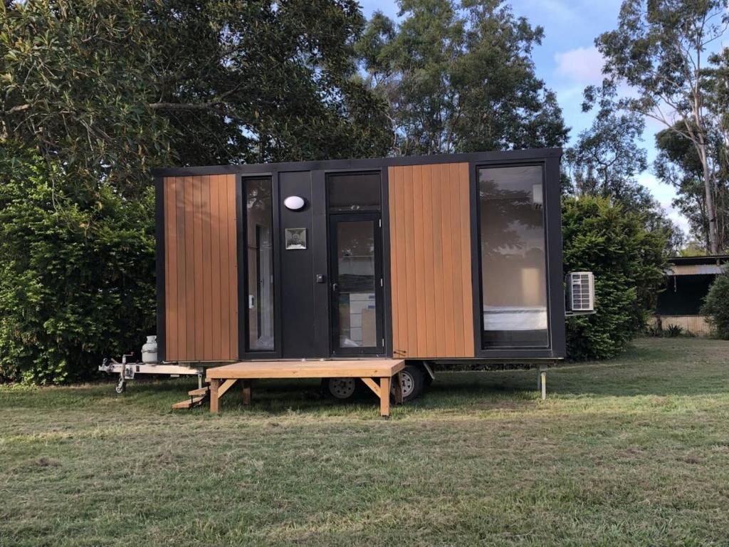 a tiny house sitting on a table in a field at Makowata Farm in Colosseum