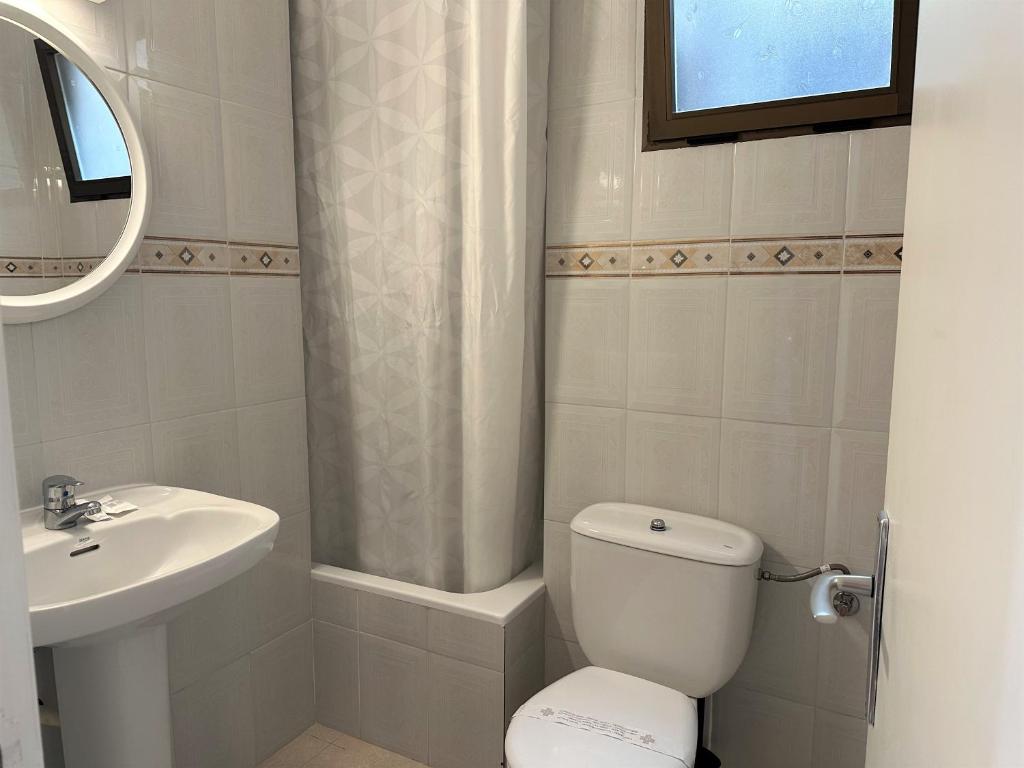 a bathroom with a toilet and a sink at Hotel Rosamar - Emar Hotels in Es Pujols