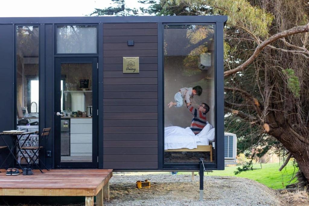 a man and a woman in a tiny house at Forest Hill Farm in Herbert