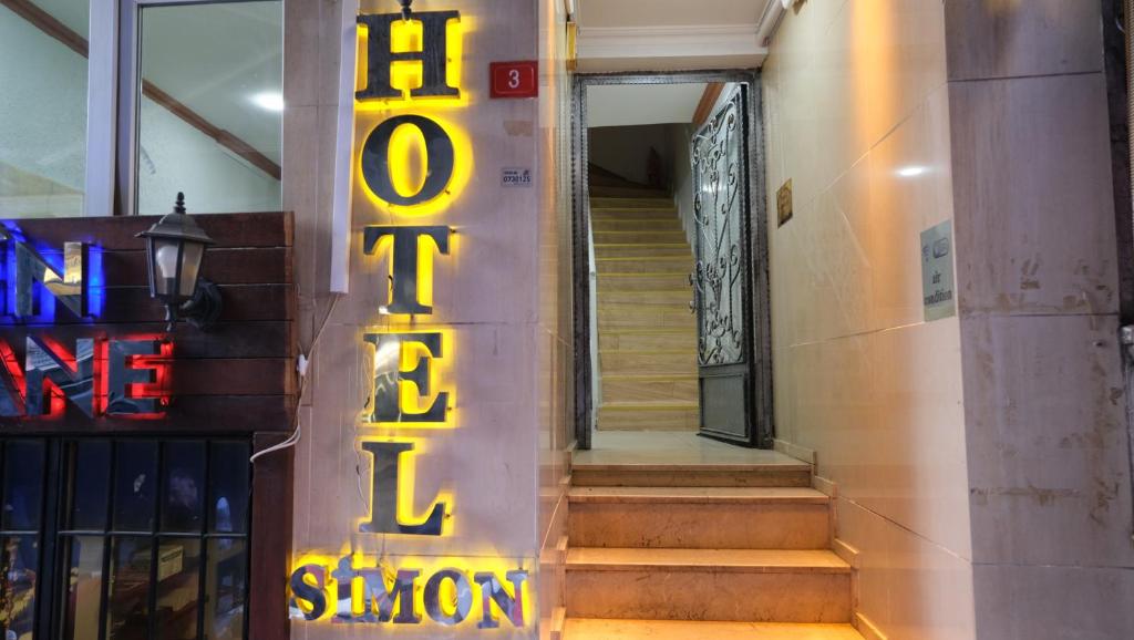 a neon sign for a subway station on a staircase at Simon Hotel in Istanbul