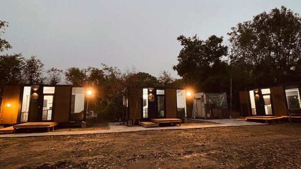 a group of tiny houses with benches and lights at Gandan Inn3 in Douliu