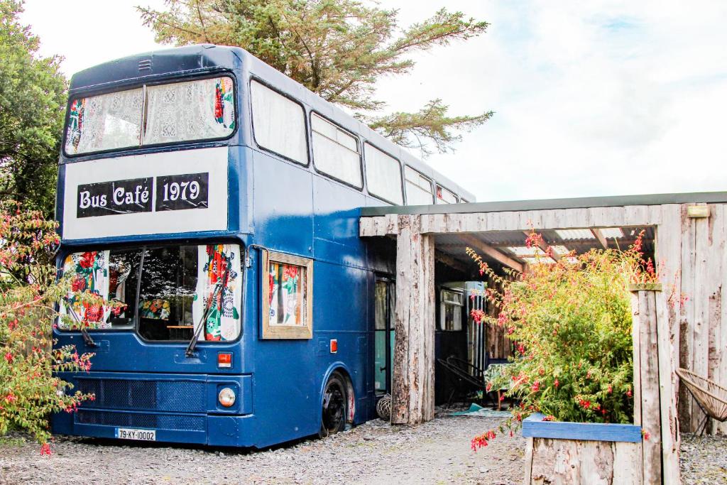 ein blauer Doppeldeckerbus neben einem Gebäude in der Unterkunft Double decker bus at Valentia Island Escape in Valentia Island