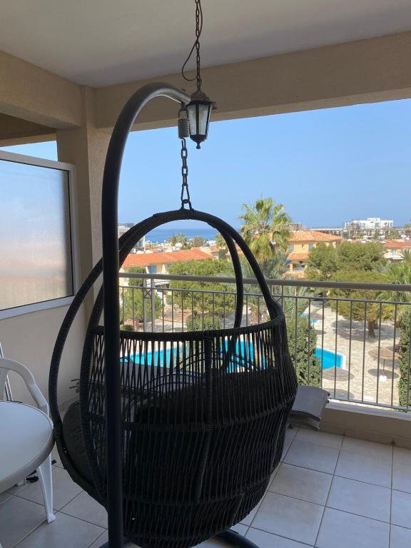 a basket swing hanging from a balcony with a view at Newly renovated- Regina Gardens 1, Venus Beach 500 m, Sea&Sunsets view, license oo12075 in Paphos