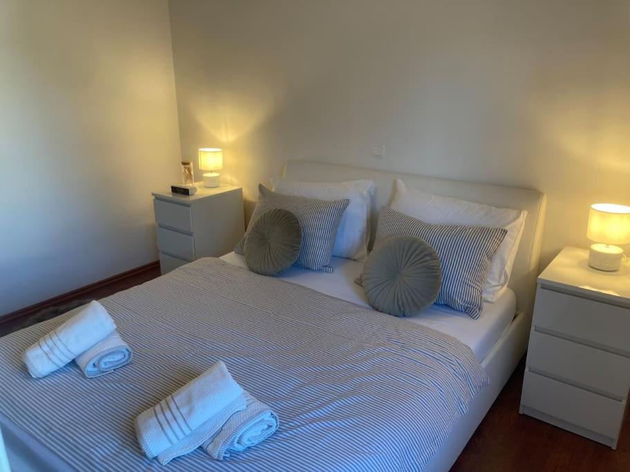 a bedroom with a white bed with blue pillows at Central City Nest - Sandra&David in Zadar