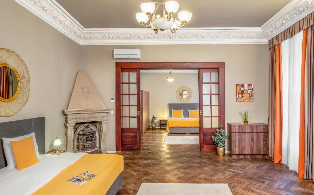 a living room with a bed and a fireplace at Hotel "Palác U Kočků" by Adrez, Palace At the Cats in Prague