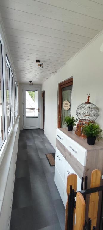 a hallway of a home with white walls and windows at Apartma Soča Oasis in Srpenica