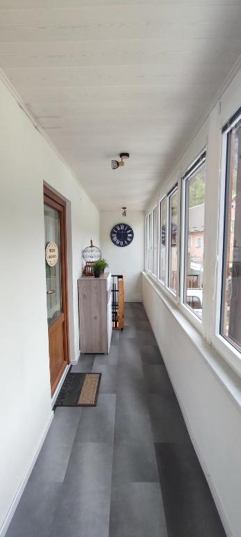a hallway of a house with a door and windows at Apartma Soča Oasis in Srpenica