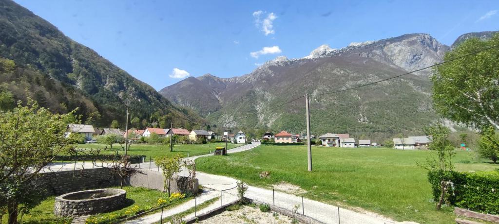 a village in a valley with mountains in the background at Apartma Soča Oasis in Srpenica