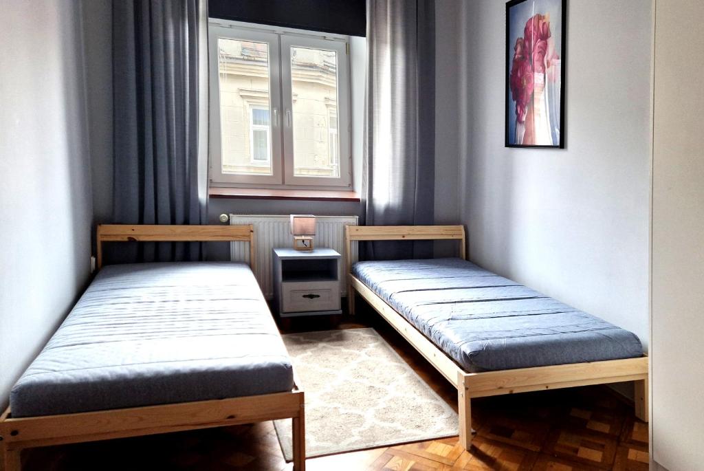 Posteľ alebo postele v izbe v ubytovaní Apartament Peowiaków Superior