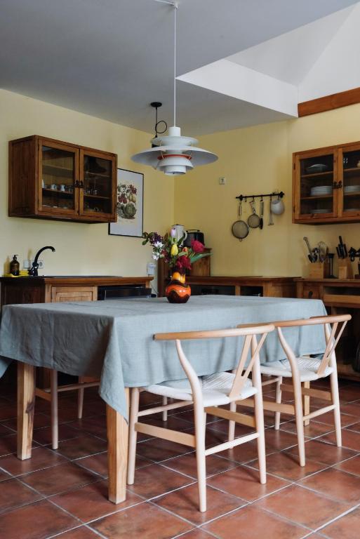 a kitchen with a table with a blue table cloth at Apfelhof Biesenbrow in Biesenbrow