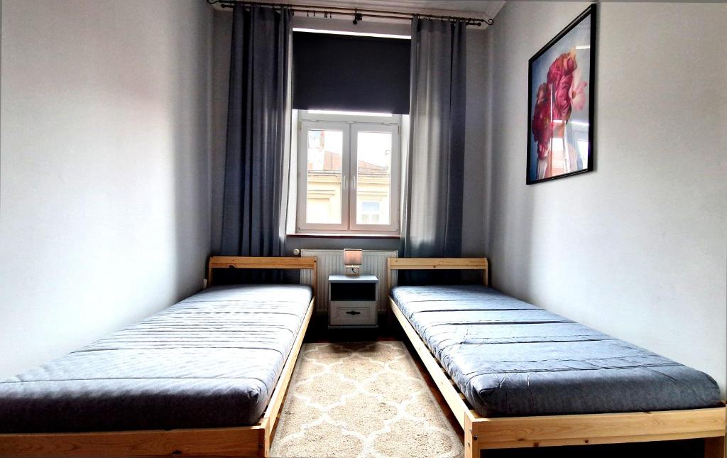 Posteľ alebo postele v izbe v ubytovaní Apartament Peowiaków Superior