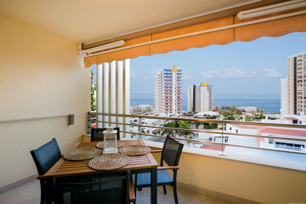a dining room with a table and chairs and a balcony at 422 Quiet, beautiful flat with sea view in Playa Paraiso