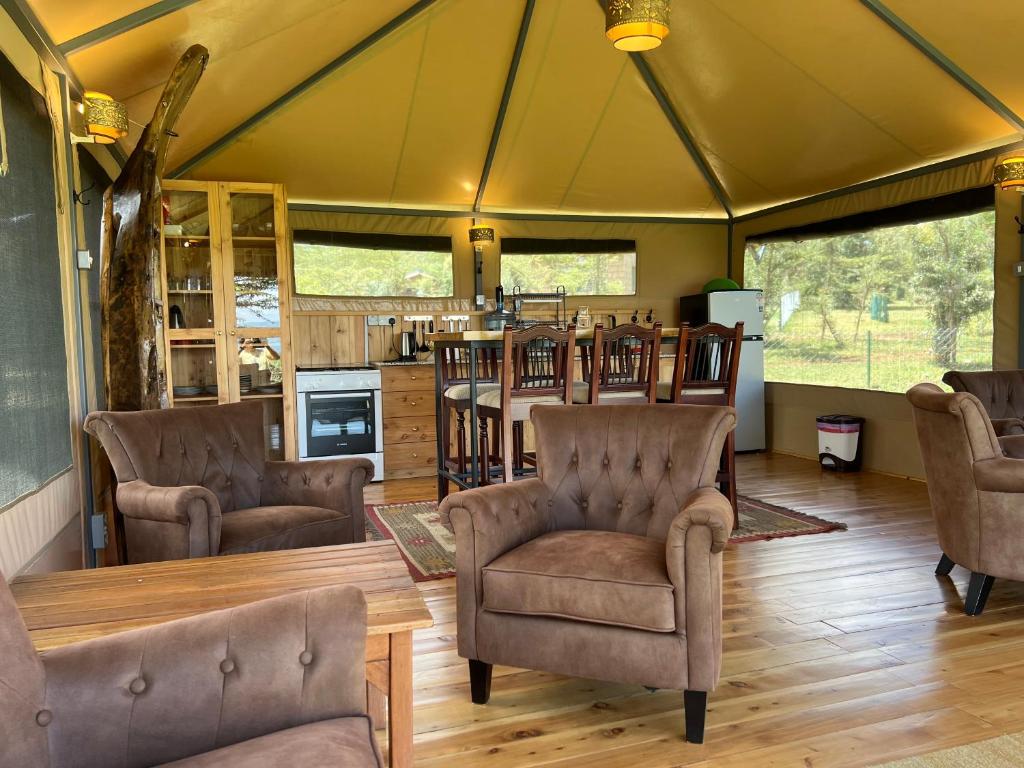 a room with chairs and a table in a tent at Nyumba ya Farasi in Naivasha