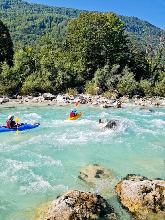 a group of people kayaking on a river at Apartma Soča Oasis in Srpenica