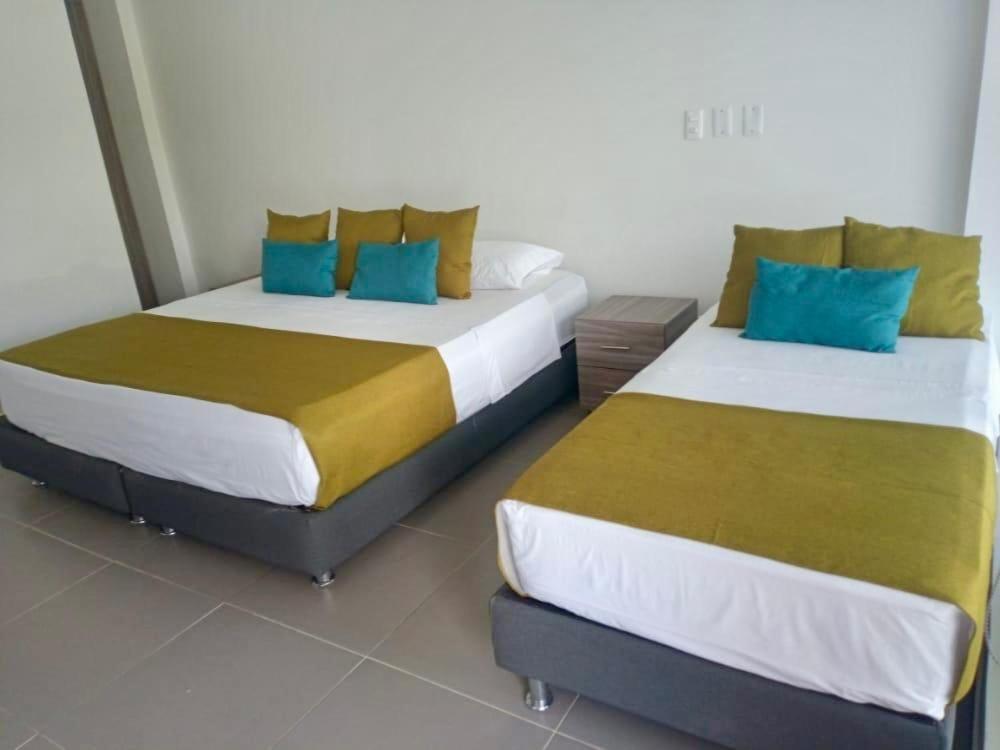 two beds sitting next to each other in a room at Finca Hotel Santa Catalina in La Rochela