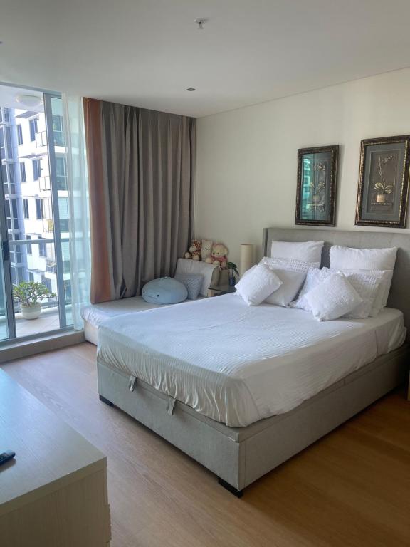 - une chambre avec un grand lit et des oreillers blancs dans l'établissement Amazing water view class large holiday home, à Gold Coast