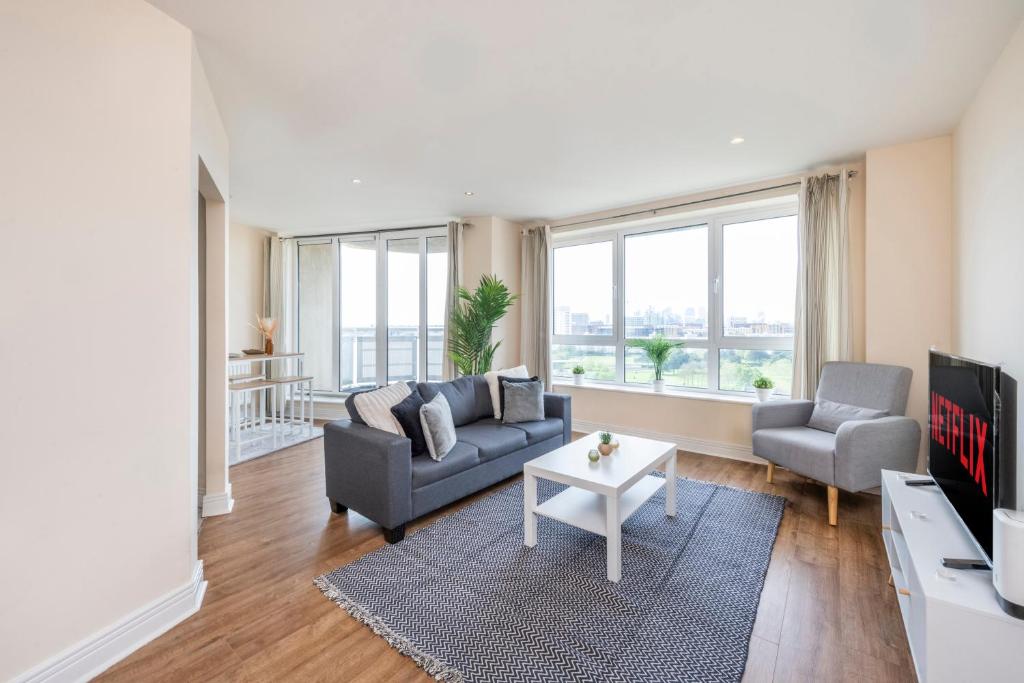 a living room with a couch and a tv at River View 2 Bed 2 Bath Flat - London City Airport, Excel, Pontoon Dock in London