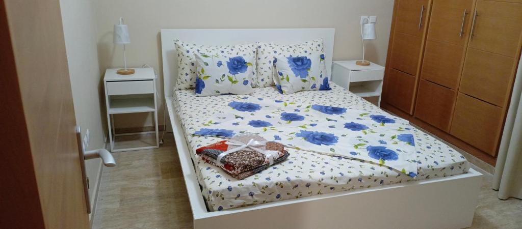 a bedroom with a bed with blue flowers on it at شقة مع اطلالة رائعة على البحر in Rabat