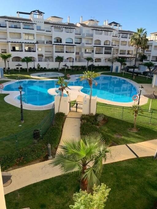 a large apartment building with a large swimming pool at Apartamentos Residencial Duquesa in San Luis de Sabinillas