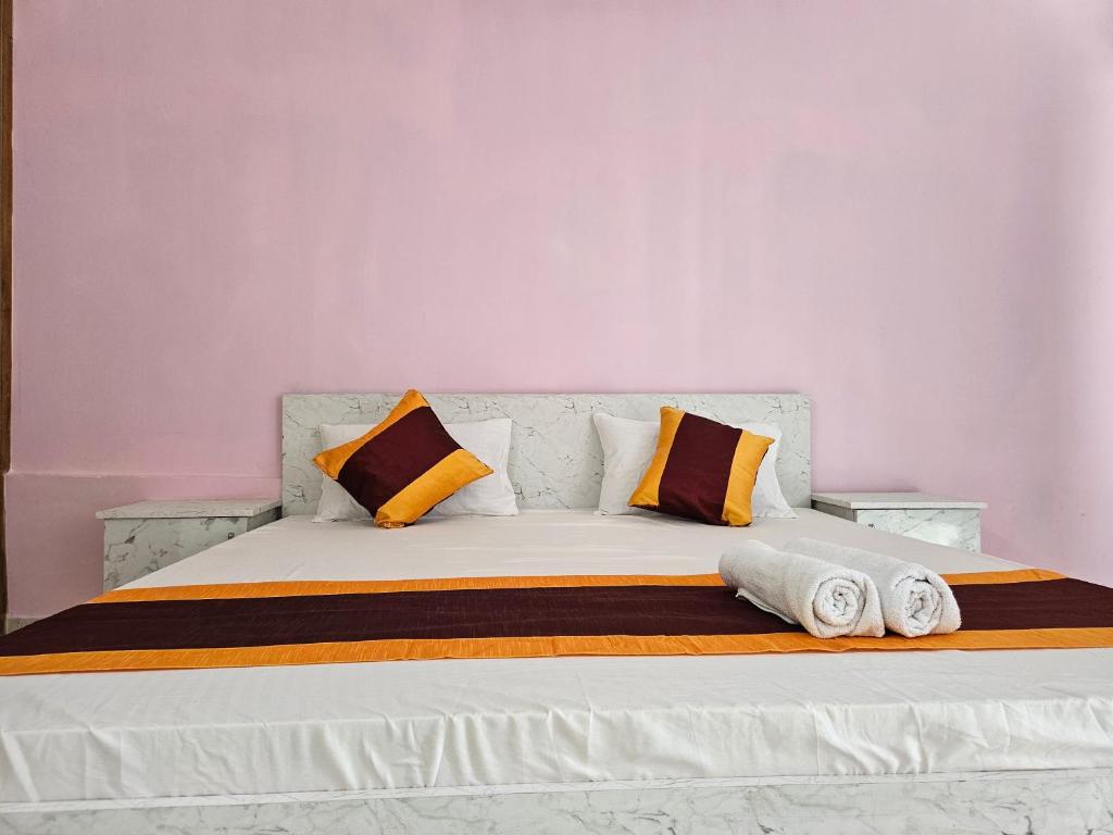 a bed with two pillows and towels on it at homeystay urbandream service apartment in Faridabad