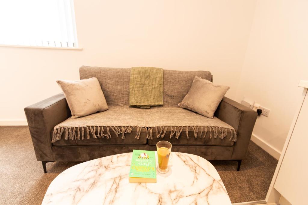 a living room with a couch and a coffee table at Cosy Retreat in the heart of Preston in Preston