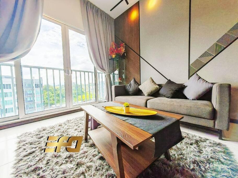 a living room with a couch and a table at Stylish Apartment and Cozy Feel in Kuching