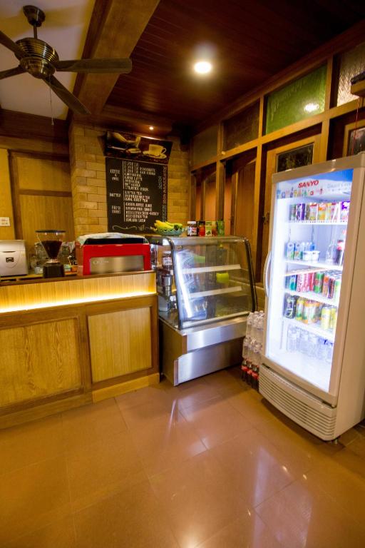 a kitchen with a refrigerator in a restaurant at Garden Home Kata in Kata Beach