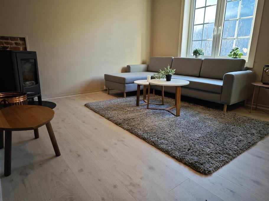 a living room with a couch and a table at Rekkehus Tyssedal Trolltunga in Tveit