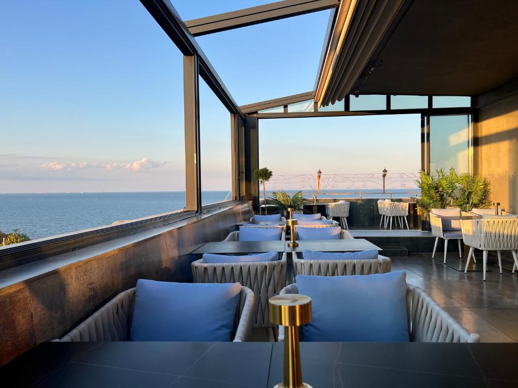 a restaurant with a view of the ocean at Hotel Cosmos in Eforie Sud