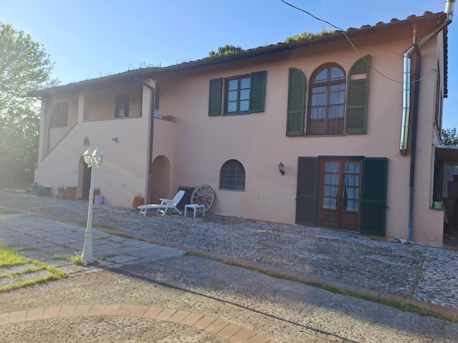 a house with a bench in front of it at Podere Travalda - appartamento in agriturismo per 4-6 persone in Pontedera