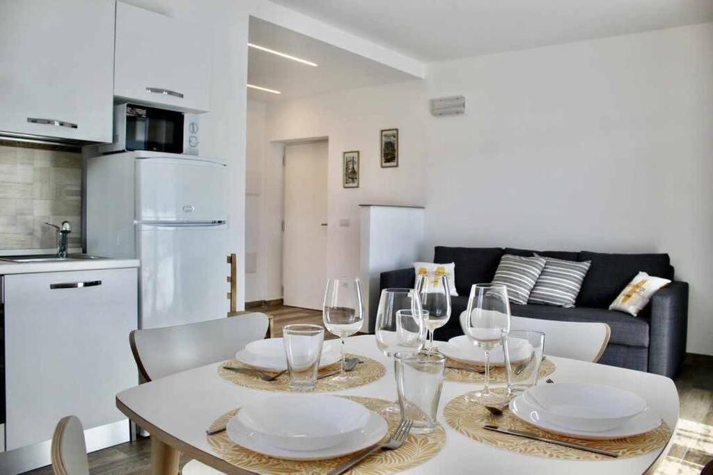 a dining room with a table with plates and wine glasses at Casa del Tempo Irma Tassullo Ospitar in Tassullo