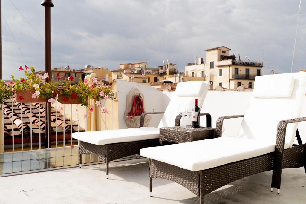 two chairs and a table on a balcony at Central View Boutique in Florence