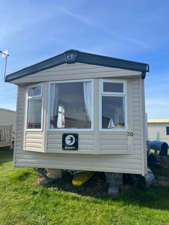 a tiny house on a trailer in the grass at Saltsea in Padstow