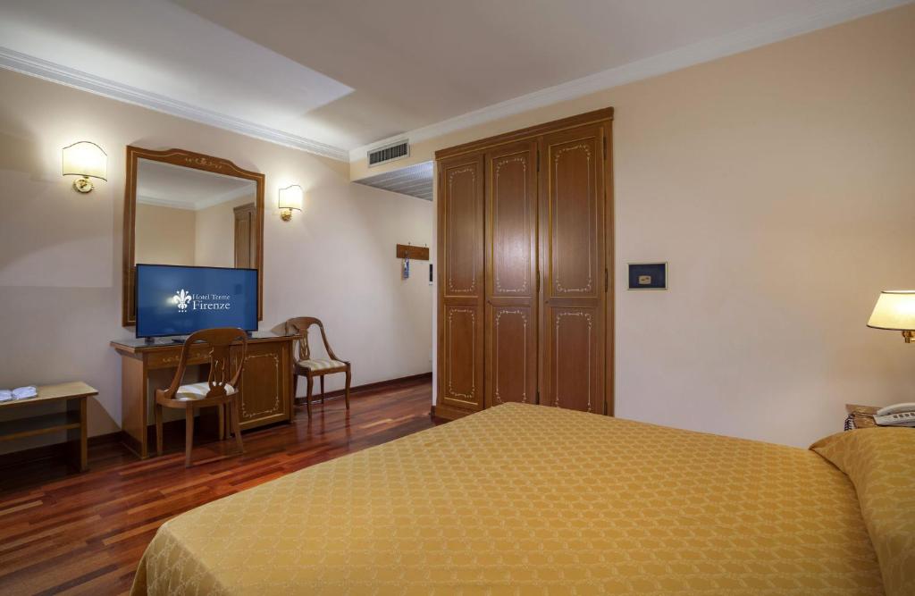 Postel nebo postele na pokoji v ubytování Hotel Firenze