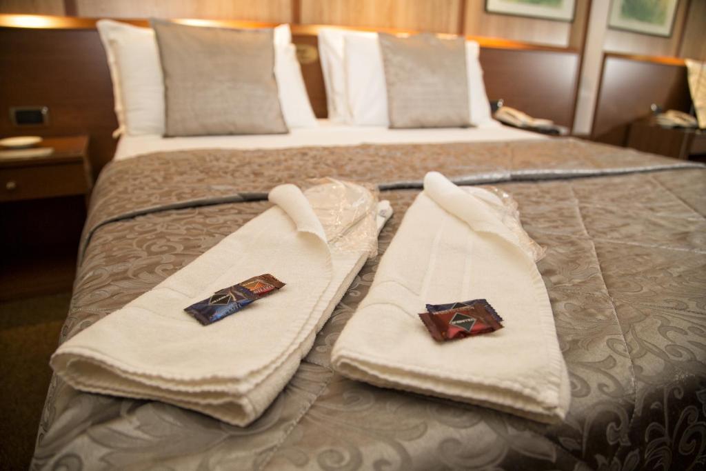 Postel nebo postele na pokoji v ubytování Hotel Motel Ovest