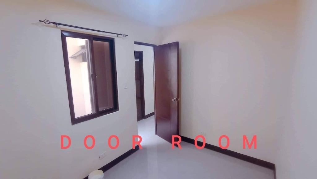 a room with two doors and a window at Parkdale apartment in Imus